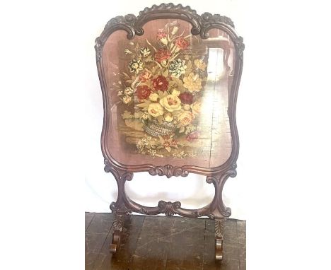 A Victorian rosewood glazed and tapestry fire screen, circa 1850, cartouche frame with a carved foliage serpentine top, glass