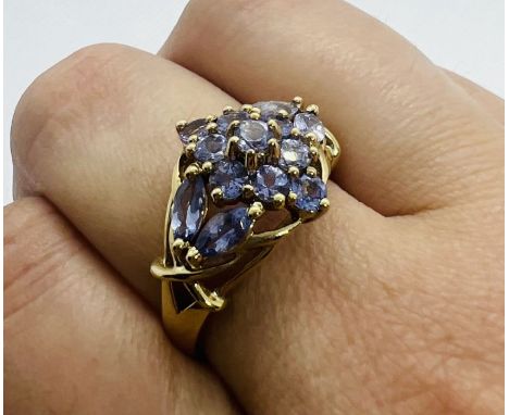 A Tanzanite set dress ring, stamped "9kt". Featuring a cluster of marquise and round cut tanzanite stones. Size R. Gross weig