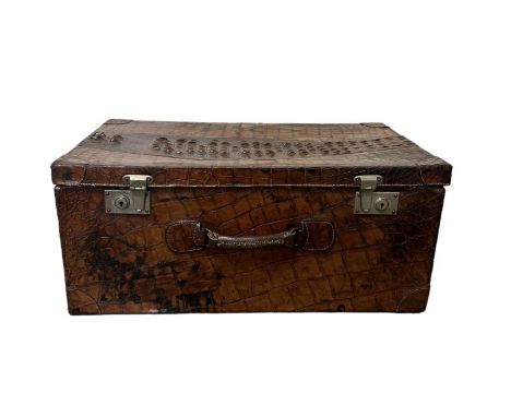 An early 20th century crocodile skin travel trunk with calf leather lining and locking clasps with original key. Exterior is 