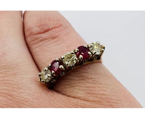 A ruby and diamond five stone ring in yellow metal, stamped 14k. Approximate gross weight 3.2 grams.