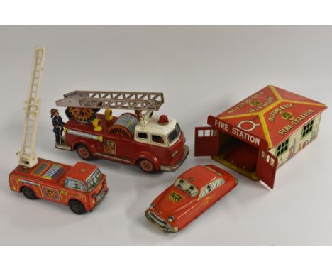 Tinplate - a Marx Automatic Fire Station, with fire engine; a small fire engine with plastic ladder, made in Japan; a fire en
