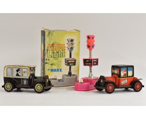 A Daiya police car, tinplate, friction, engine moves back and forth, made in Japan; a Test Drive car, by Daiya, friction, eng
