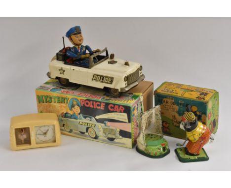 Tinplate - a Bear Golfer, mechanical toy, made in Japan by TPS, in original box; a  Mystery Police Car, by TN, made in Japan,