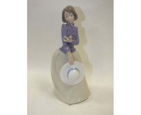 A NAO LADY FIGURE WITH BIRD IN HAND