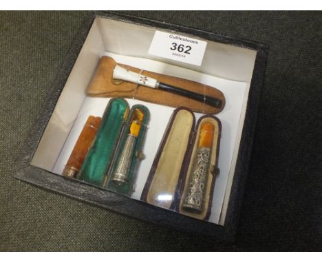 A BOXED DISPLAY CONTAINING HALLMARKED GOLD AND SILVER CHEROOT HOLDERS TO INCLUDE AN ENAMEL EXAMPLE