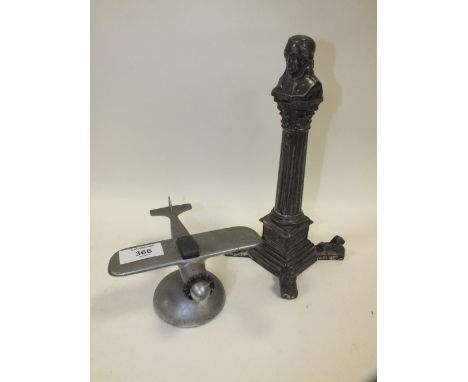AN UNUSUAL TABLE LIGHTER IN THE FORM OF A PILLAR MONUMENT OF NELSON A/F TOGETHER WITH AN AEROPLANE TABLE LIGHTER 