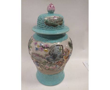 A LARGE CHINESE CERAMIC RELIEF MOULDED TEMPLE JAR AND COVER DECORATED WITH VARIOUS FIGURES AND TREES WITH IMPRESSED STAMP TO 