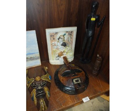TWO TRIBAL STYLE MASKS AND A CARVED WOODEN FIGURE AND A CERAMIC PLAQUE