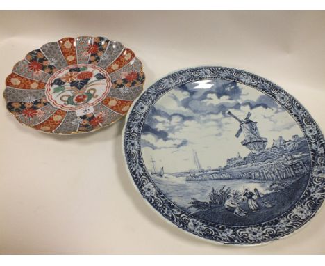 A DELFT BOCH BLUE AND WHITE CERAMIC CHARGER TOGETHER WITH A JAPANESE EXAMPLE (2)