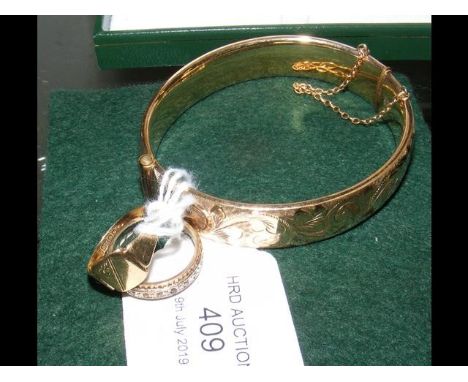 A gold signet ring, together with one other and a bangle 