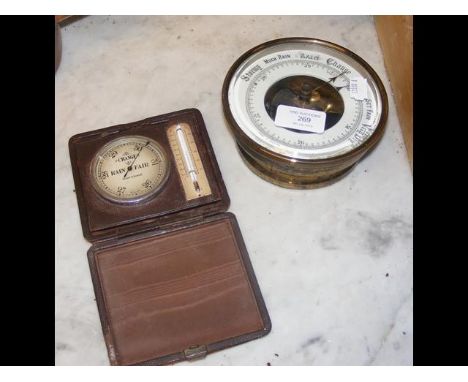 A circular barometer, together with a travelling barometer/thermometer 