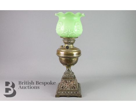 Late Victorian brass and copper oil lamp, having a brass oil reservoir with a green glass shade, approx 50 cms h.&nbsp;