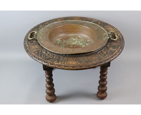18/19th century Spanish brazier, twin handled copper basin sits within a decorative foliate carved oak frame, raised on three