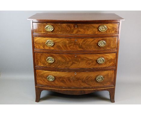 Georgian bow front mahogany and oak chest of drawers. The chest having four graduated drawers with decorative box stringing, 