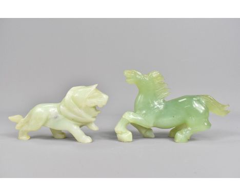 Two celadon jade carvings, depicting a lion approx 6 x 11 x 3 cms and a horse approx 9 x 14 x 3 cms.&nbsp;