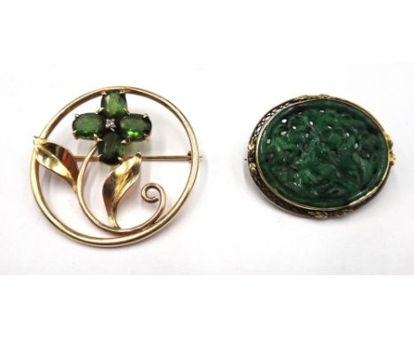 A gold, green tourmaline and diamond set brooch, in a circular openwork design as a floral spray, claw set with four oval cut