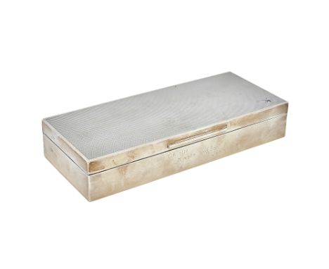 A silver rectangular, hinge lidded table cigarette box, wooden lined within, the lid engine turned, the front inscribed Crimm