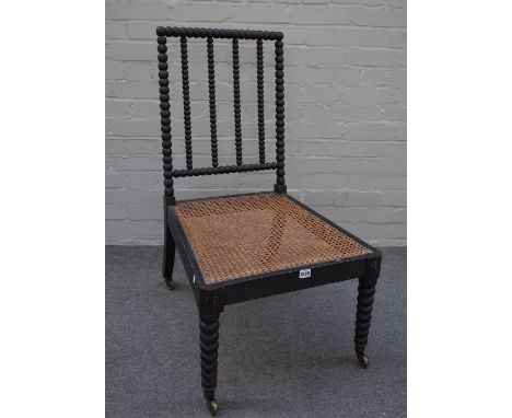 A Regency ebonised side chair with bobbin turned back, legs and cane seat, 51cm wide x 95cm high. 