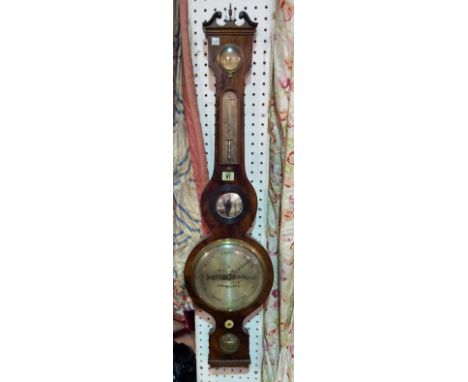 A George III mahogany wheel barometer by J & W LETTEY DUNSTER', broken arch pediment over thermometer and bullseye mirror wit