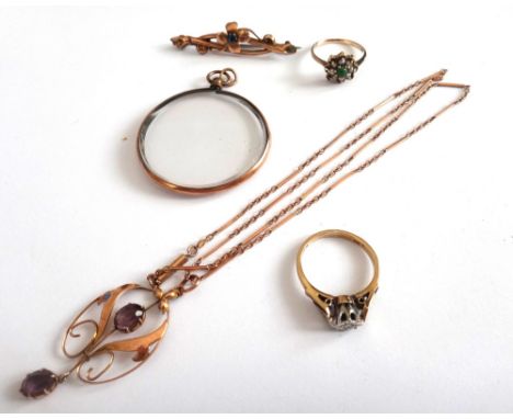 A gold and amethyst pendant, in an openwork design, mounted with two oval cut amethysts, detailed 9 CT, with a gold bar and o