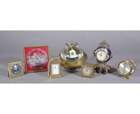 A square and red enamel strut timepiece, an octagonal shaped brass world time desk clock with glass spheres, a miniature bras