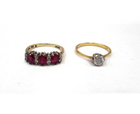 A 9ct gold, synthetic ruby and diamond ring, claw set with three oval cut synthetic rubies, alternating with four pairs of ci