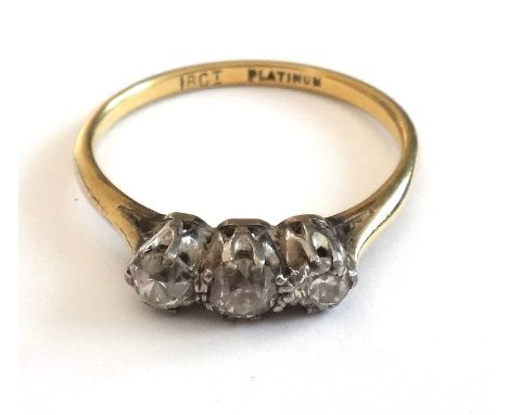 A gold and platinum, diamond set three stone ring, claw set with a row of cushion shaped diamonds, detailed 18 CT PLATINUM, r