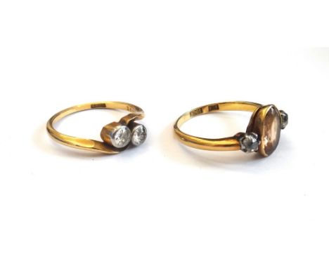 A gold and diamond set two stone ring, mounted with cushion shaped diamonds in a crossover design, detailed 18 CT, ring size 