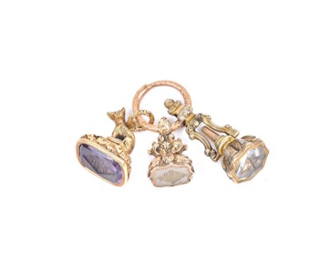 A Victorian amethyst set pendant fob seal, the top with a seated fox motif, a Victorian chalcedony set pendant fob seal, both