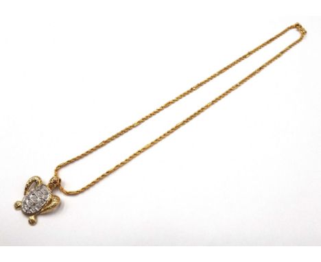 A gold and diamond set pendant, designed as a turtle, detailed 750, with a gold ropetwist and multiple link neckchain, on a s