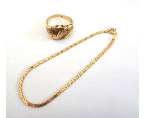 A gold and synthetic ruby set ring, with a spray motif to the centre, ring size N 1/2 and a gold multiple link bracelet, on a