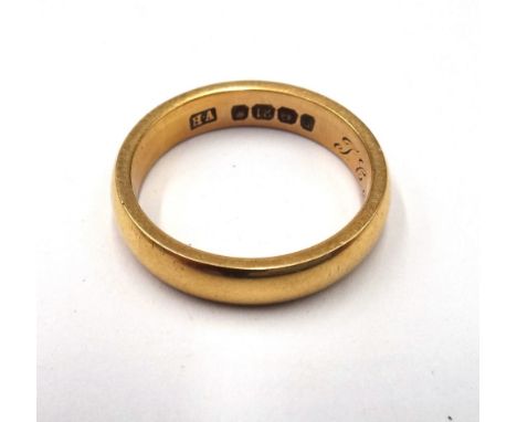 An 18ct gold wedding ring, engraved with initials and date within the band, Birmingham probably 1903, ring size O, weight 6.4