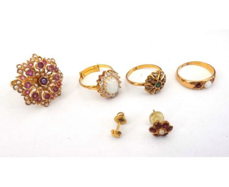 A gold, opal and garnet set three stone ring, an opal and colourless gem set oval cluster ring, two gold, seed pearl and gem 