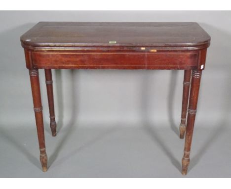 A Regency mahogany brass inlaid card table on ring turned tapering supports, 92cm wide x 77cm high. 