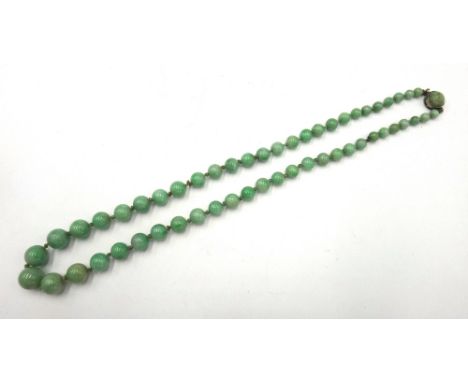 A single row necklace of graduated spherical jade beads, on a jade set clasp, length 42cm.