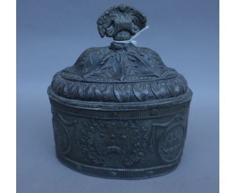 An 18th century pewter tobacco box and cover, possibly Leeds, embossed decoration of hanging sheep against an oval body (16cm