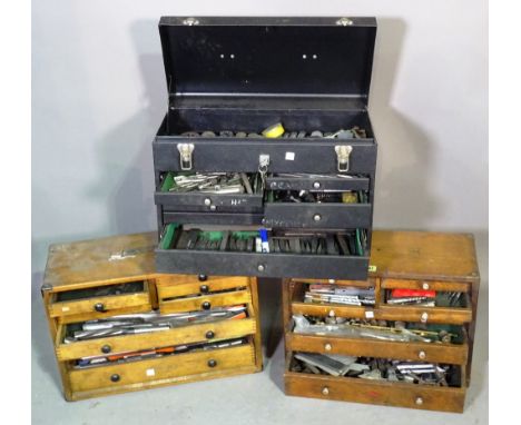 A group of three watchmakers tool chests containing tools. 