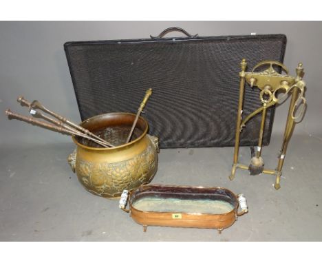 Metalware, including; a quantity of fire tools, two copper embossed jardinieres and a wrought iron mesh fire screen, (qty). 
