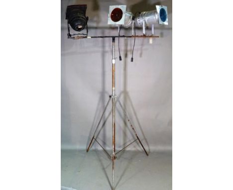 A large theatrical light stand fitted with three theatre lights. 