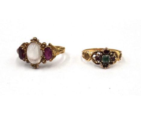 A gold, moonstone and garnet set three stone ring, mounted with the oval moonstone to the centre, between two oval cut garnet