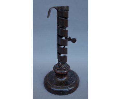 A sheet brass Hogscraper candlestick, circa 1790, 18cm high, an 18th century wrought iron and fruitwood adjustable candlestic