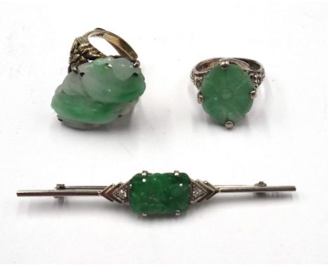 A white gold and platinum, jade and diamond bar brooch, mounted with the rectangular carved and pierced jade to the centre, b