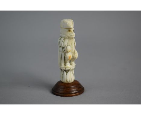 A 19th Century Carved French Ivory Novelty in the Form of Seated Metamorphic Monkey Wearing Cloak and Sailors Hat Holding Glo