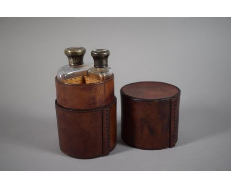 A Victorian Cylindrical Leather Field Flask Case Containing Two Silver Mounted Glass Bottles, London 1897. 