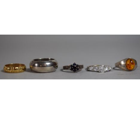 A Collection of Four Silver Rings and One 9 Carat Gold Band (2.7g). 