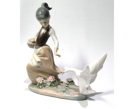 Lladro figure of a girl being chased by a goose, 20cm.