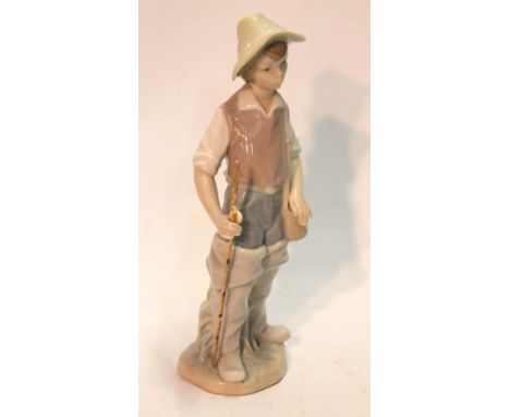 Lladro porcelain figure of a boy with a fishing rod, blue printed marks, 22cm high.