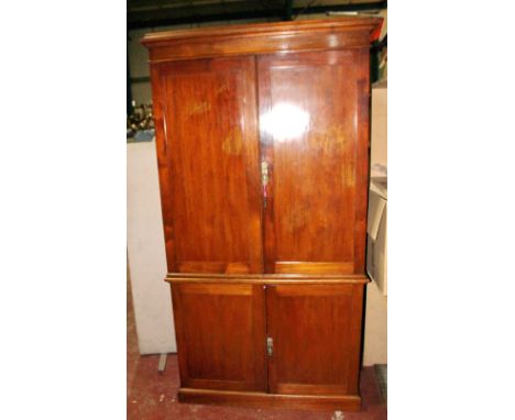 Victorian mahogany press enclosed by four panel doors, on plinth base, 105cm wide.