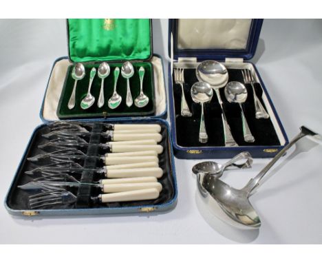Set of six EP fish knives and forks, cased, three other cased sets and a soup ladle.