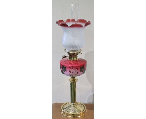 Victorian brass column table oil lamp with cranberry opaline glass reservoir and frosted cranberry glass shade, 70cm high.